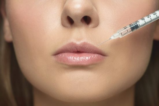 close-up-portrait-young-woman-white-studio-wall-filling-surgery-procedure-lip-augmentation_155003-35059