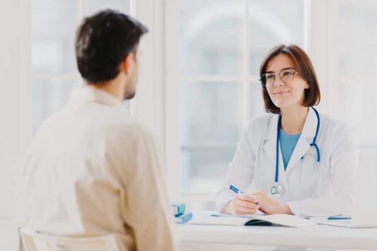 doctor-and-patient-discuss-something-sit-at-table-2022-01-11-01-44-21-utc-1024x683