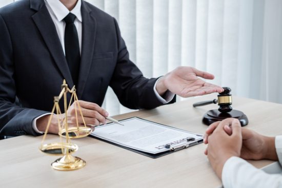 stock-photo-male-lawyer-judge-counseling-clients-judicial-justice-prosecution-scales-judges