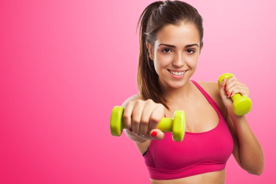 woman-smiling-while-giving-punch-with-dumbbells-hands (1)