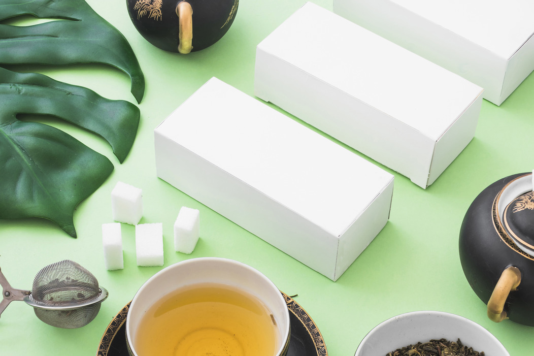 herbal-tea-sugar-cubes-tea-strainer-white-boxes-green-backdrop (1)