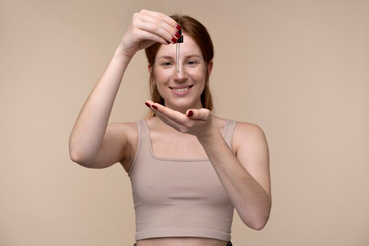 portrait-young-woman-pouring-serum-her-hand_23-2149259914